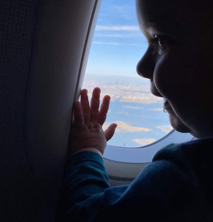 baby looking out airplane window