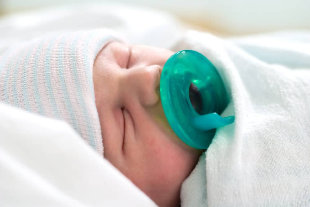 newborn baby wearing hat in hospital