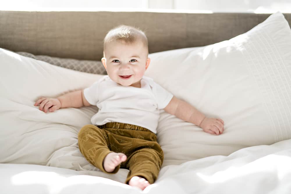 Portrait of a baby boy on the bed in bedroom