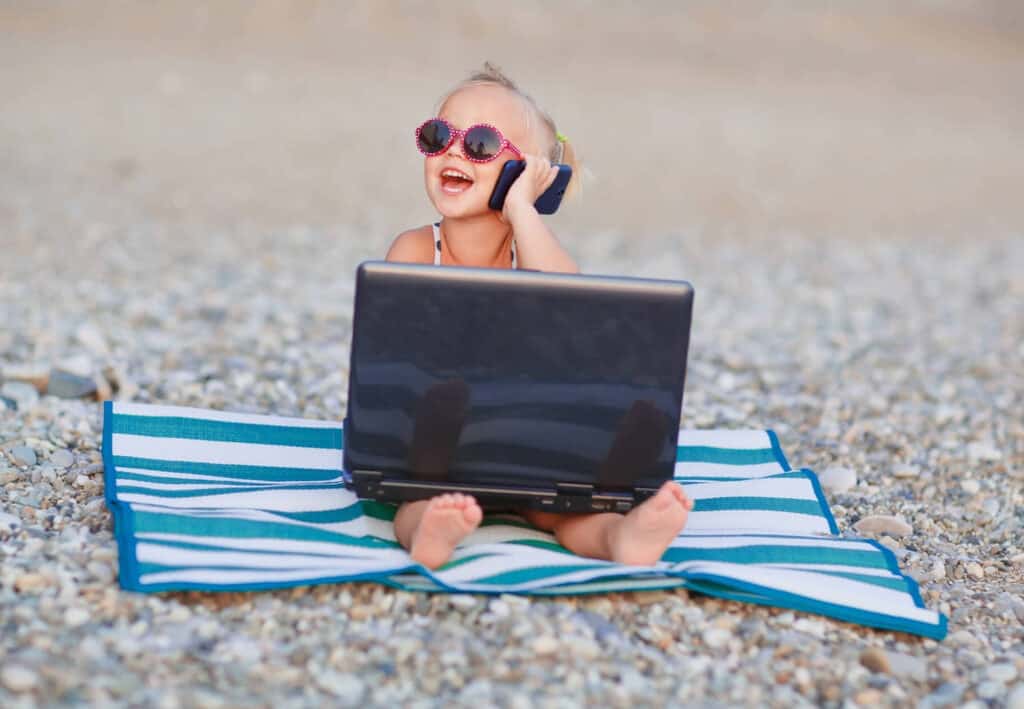 little girl laptop cell phone sunglasses beach