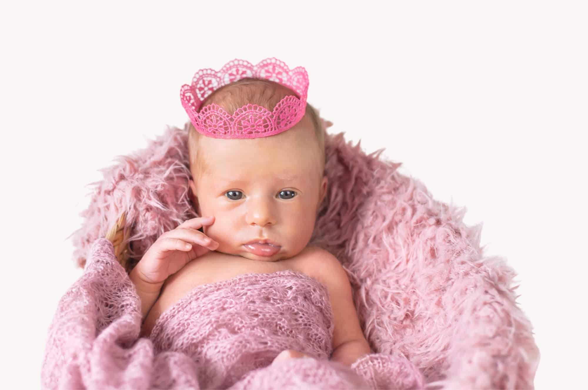 royal baby girl wearing pink crown