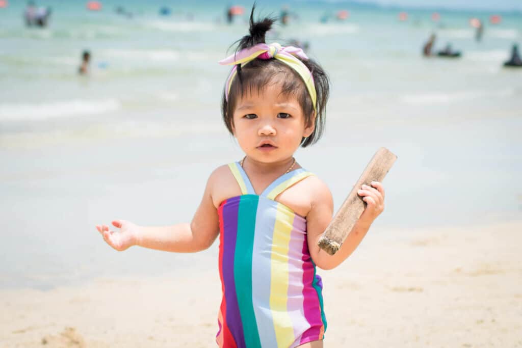 pretty asian baby striped bathing suit beach