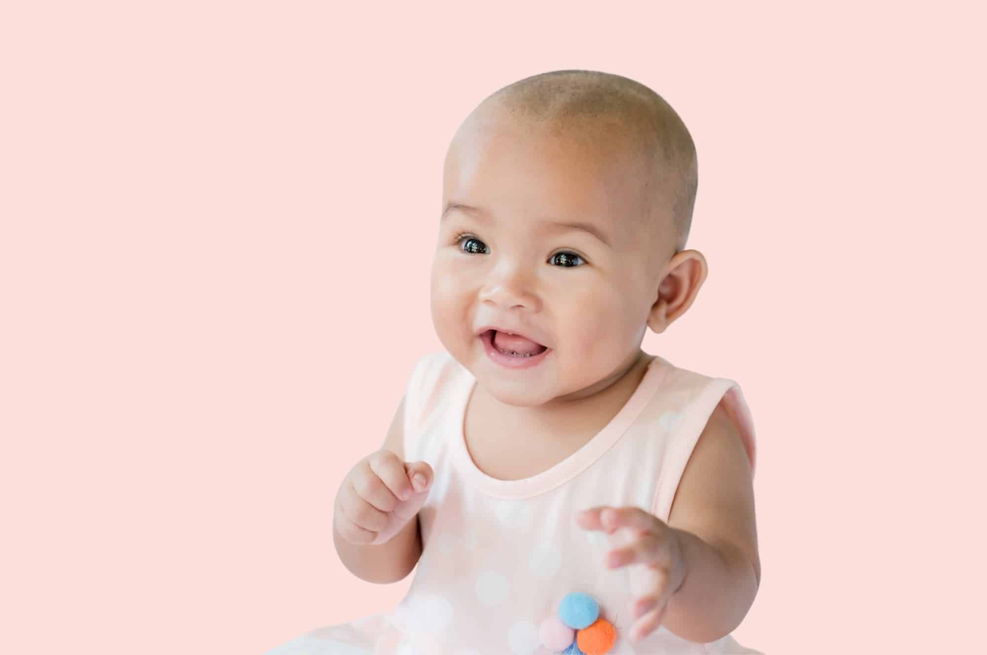 asian baby girl light pink background