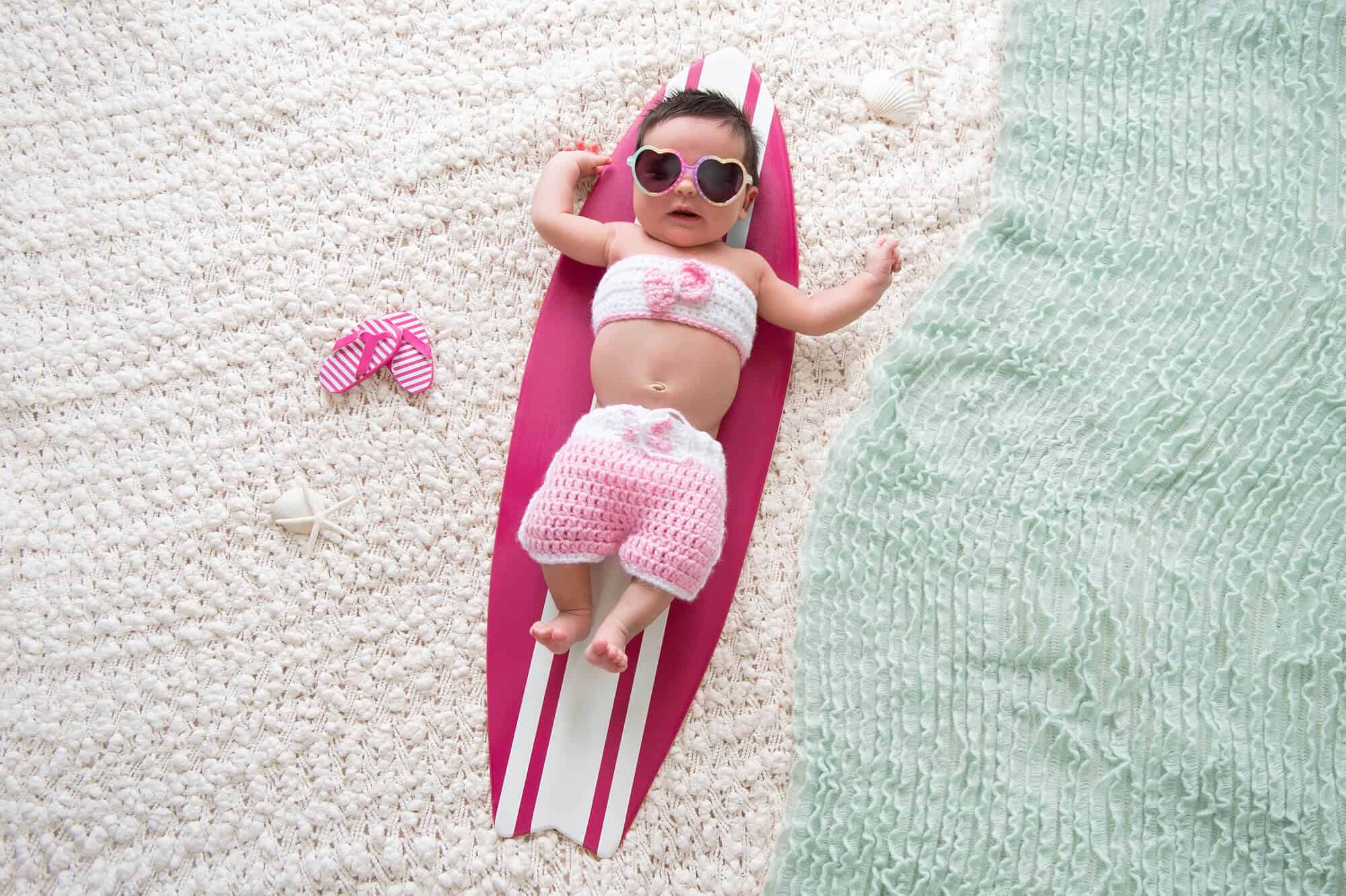 baby girl pretend beach surfboard