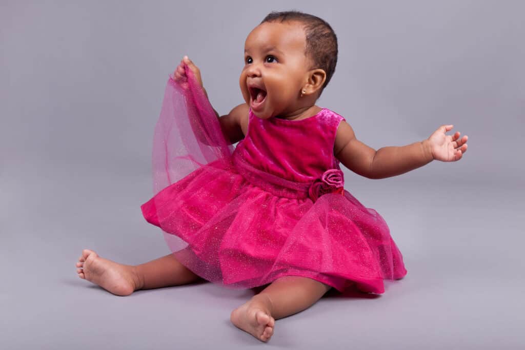 baby girl of color in pink dress