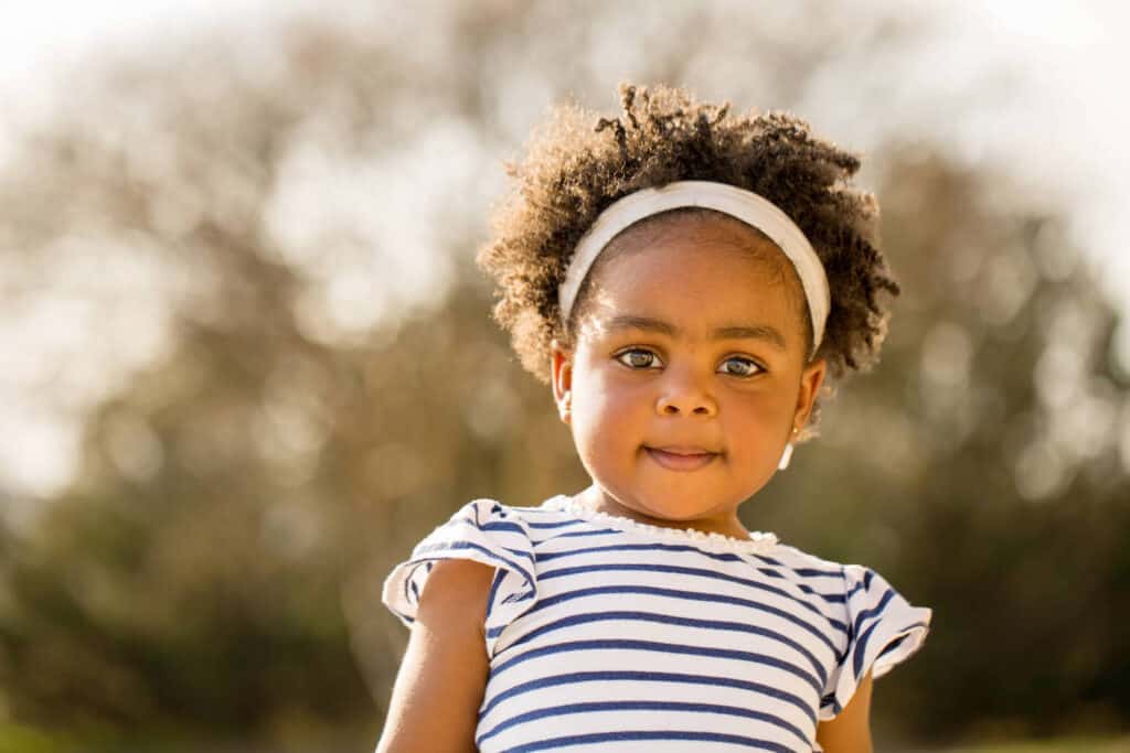 little girl of color outside wearing headband