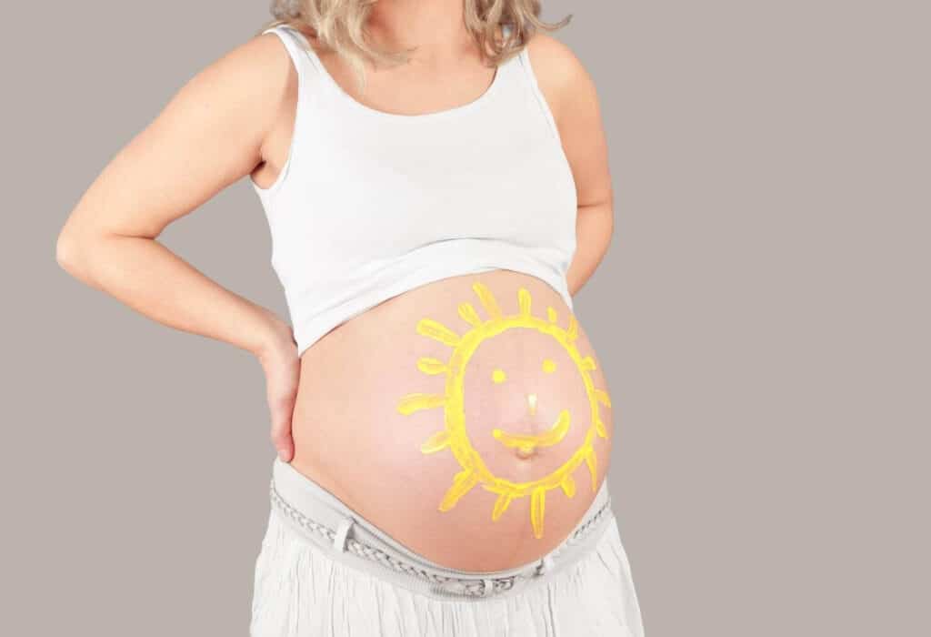 pregnant belly painted sun