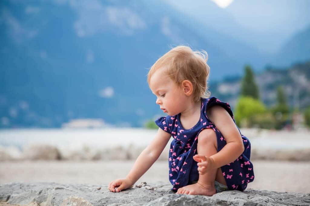 baby girl outside mountains nature