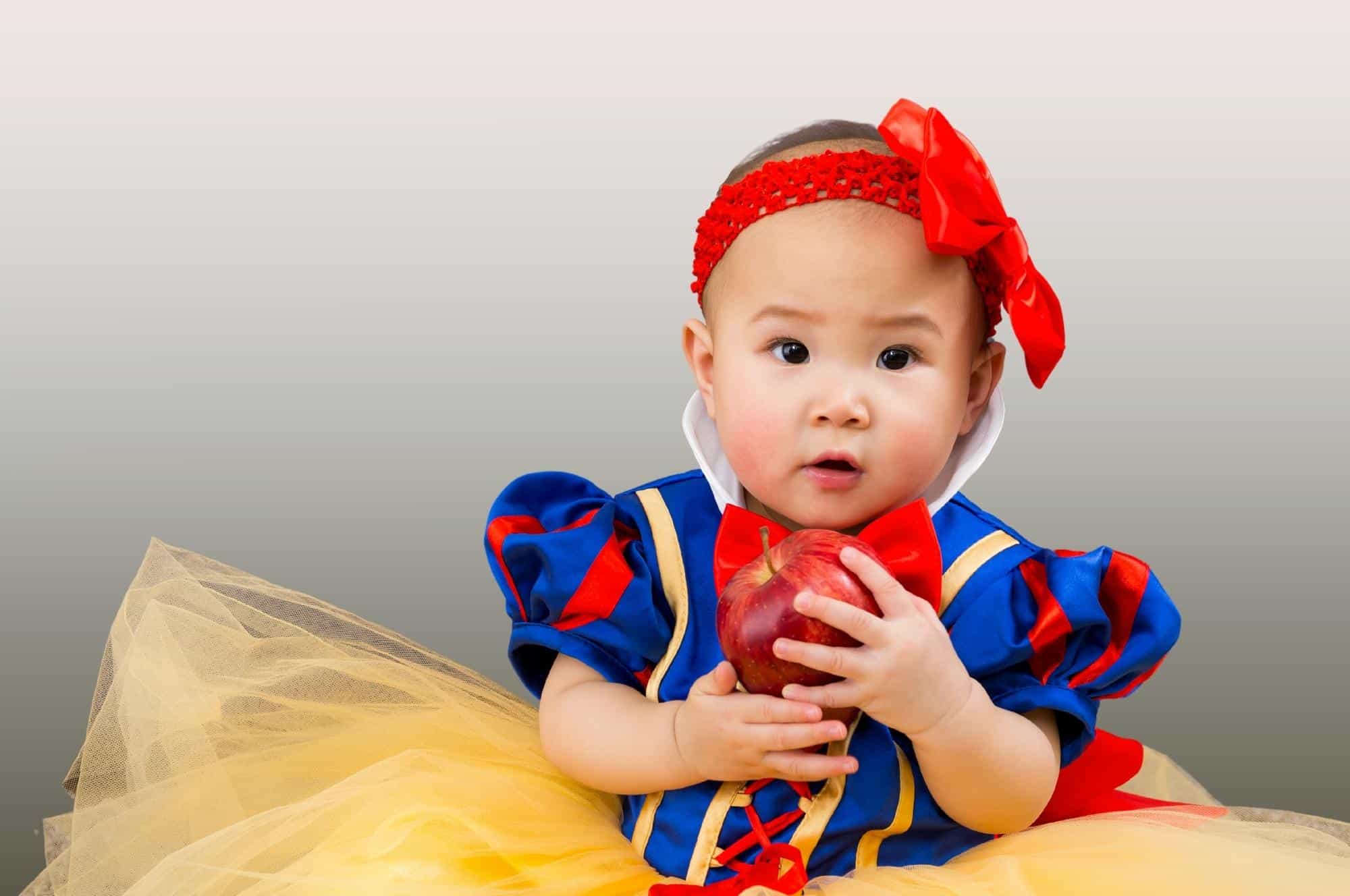 royal baby girl princess dress holding apple