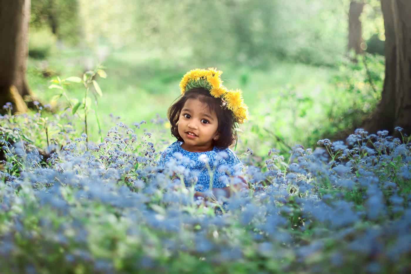 little girl in woods flowers trees