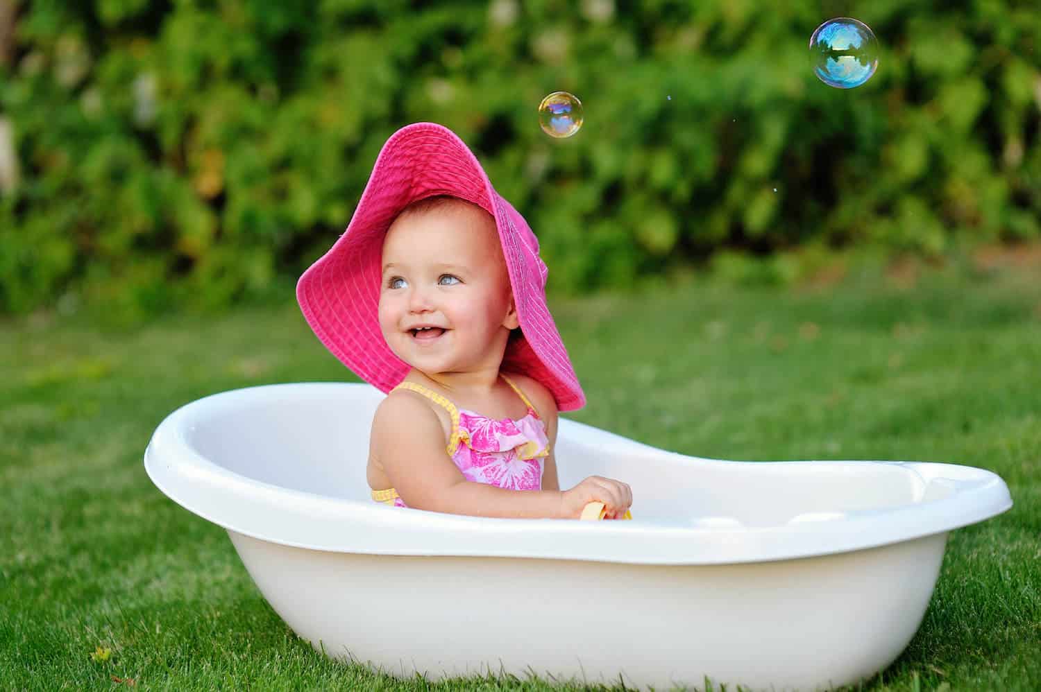 baby girl pink hat outdoors tub
