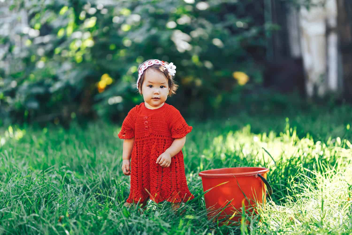 baby girl red dress garden scene