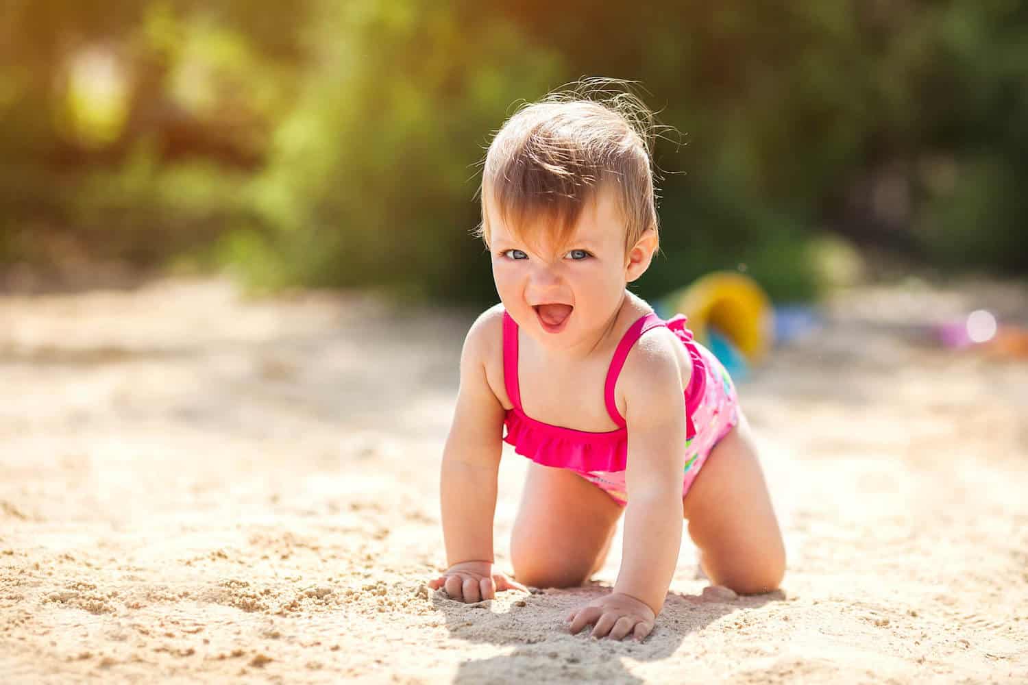 baby girl crawling in sunshine
