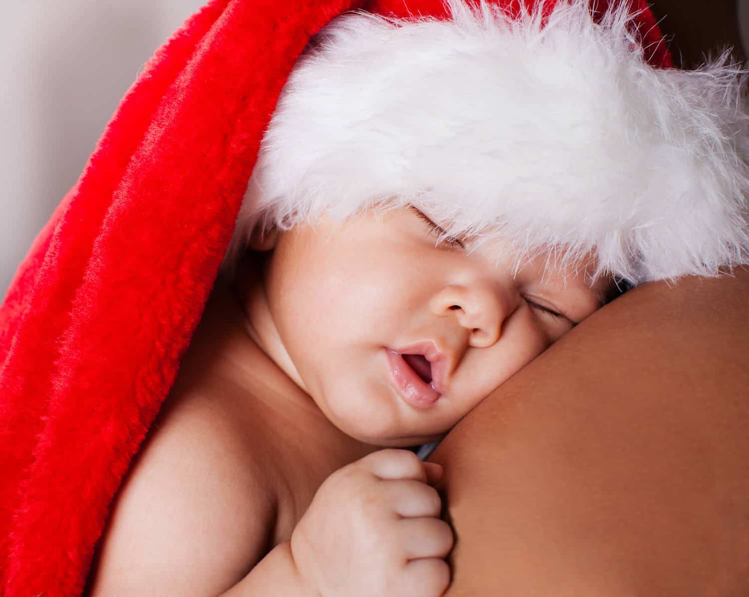 baby girl santa hat sleeping on parent