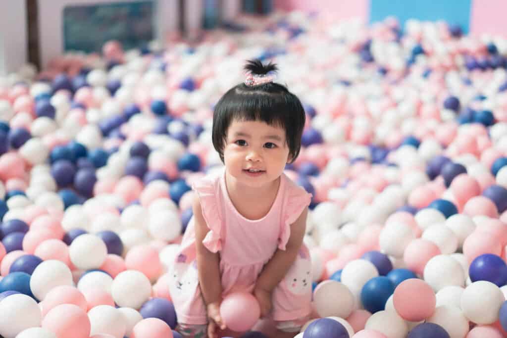 little girl in a ball pit