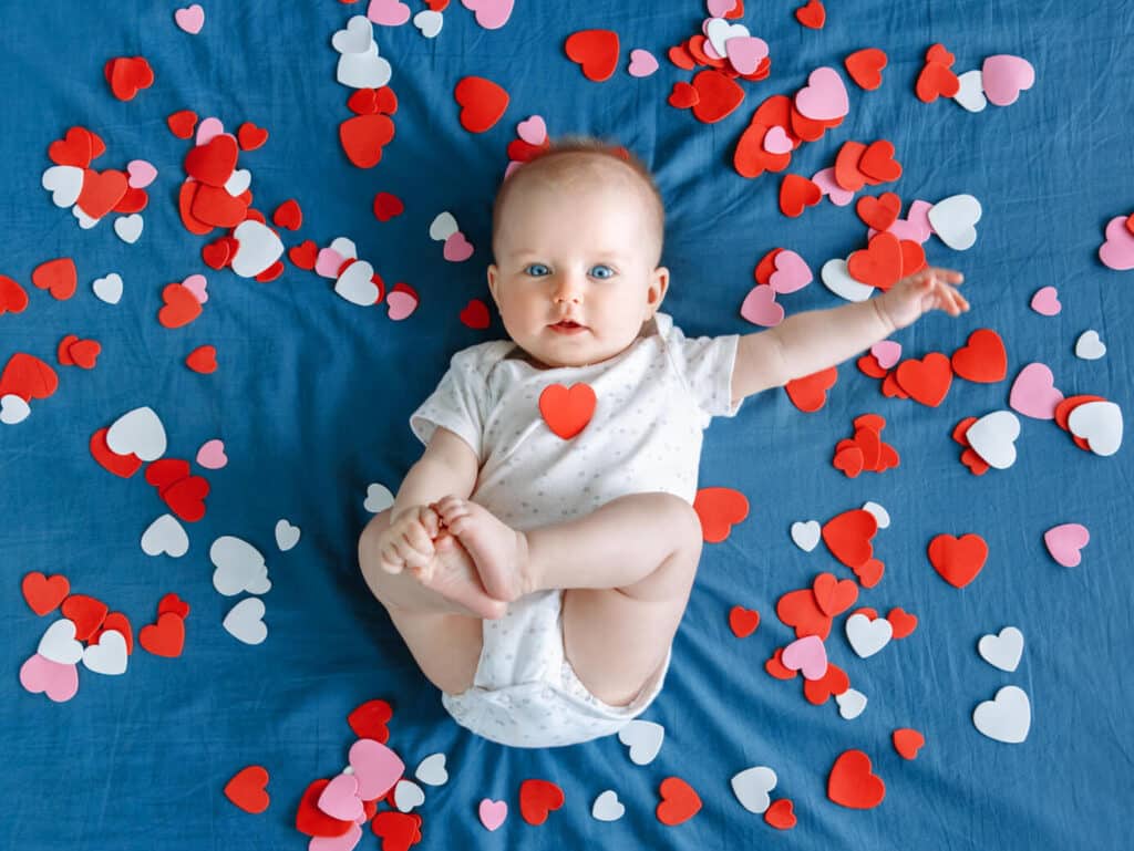 baby girl surrounded by love hearts