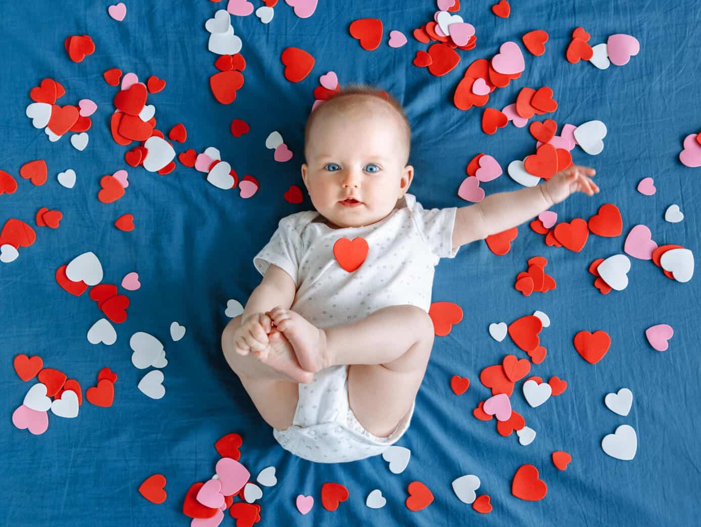 baby girl surrounded by love hearts