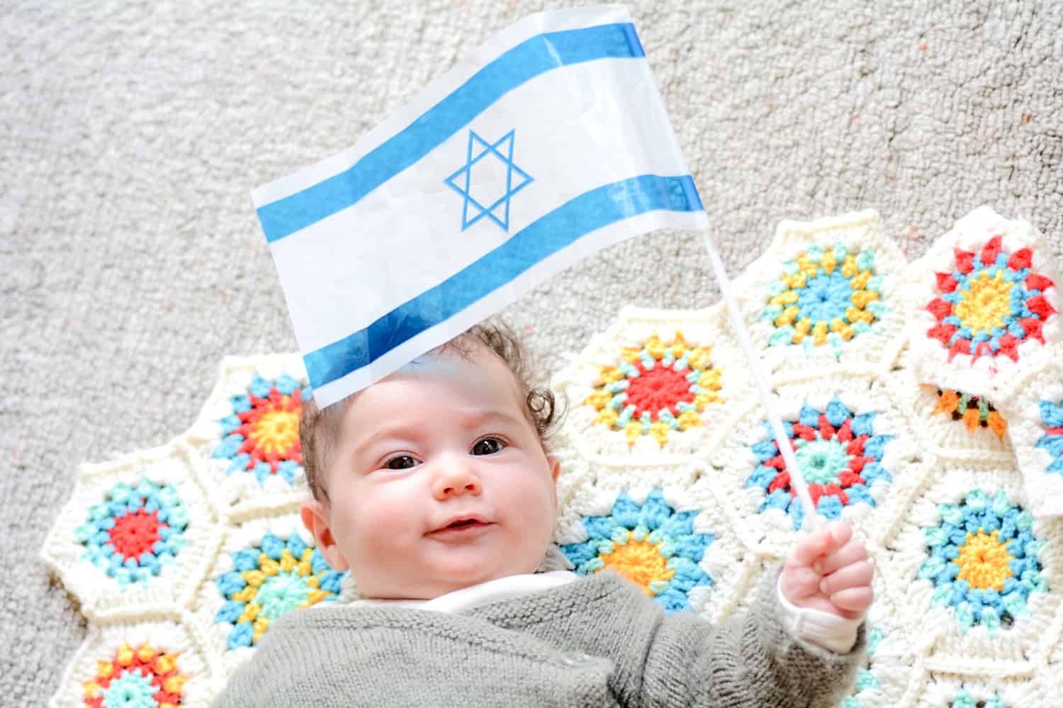jewish baby girl holding Israeli flag