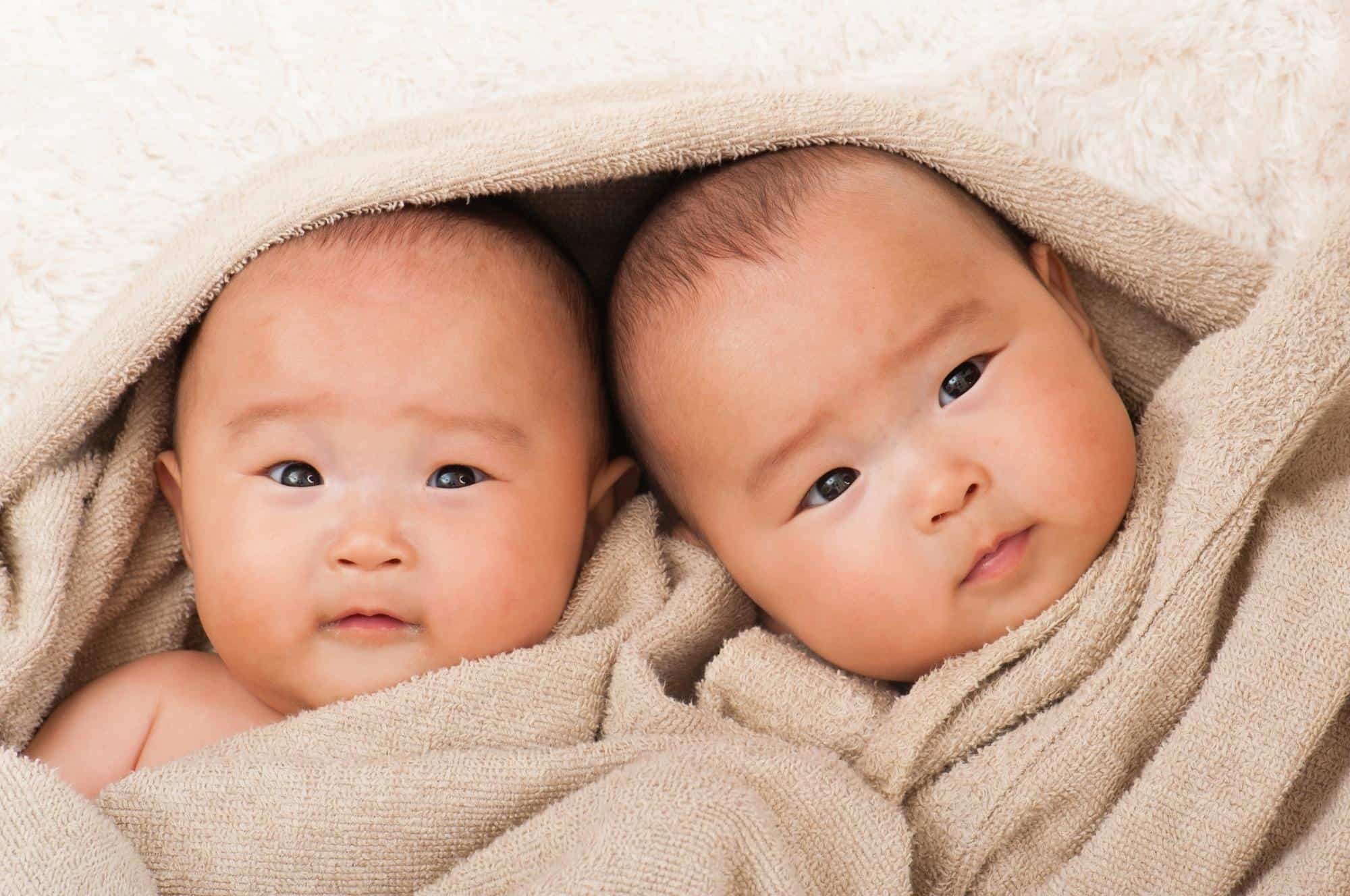 twin babies wrapped in towel