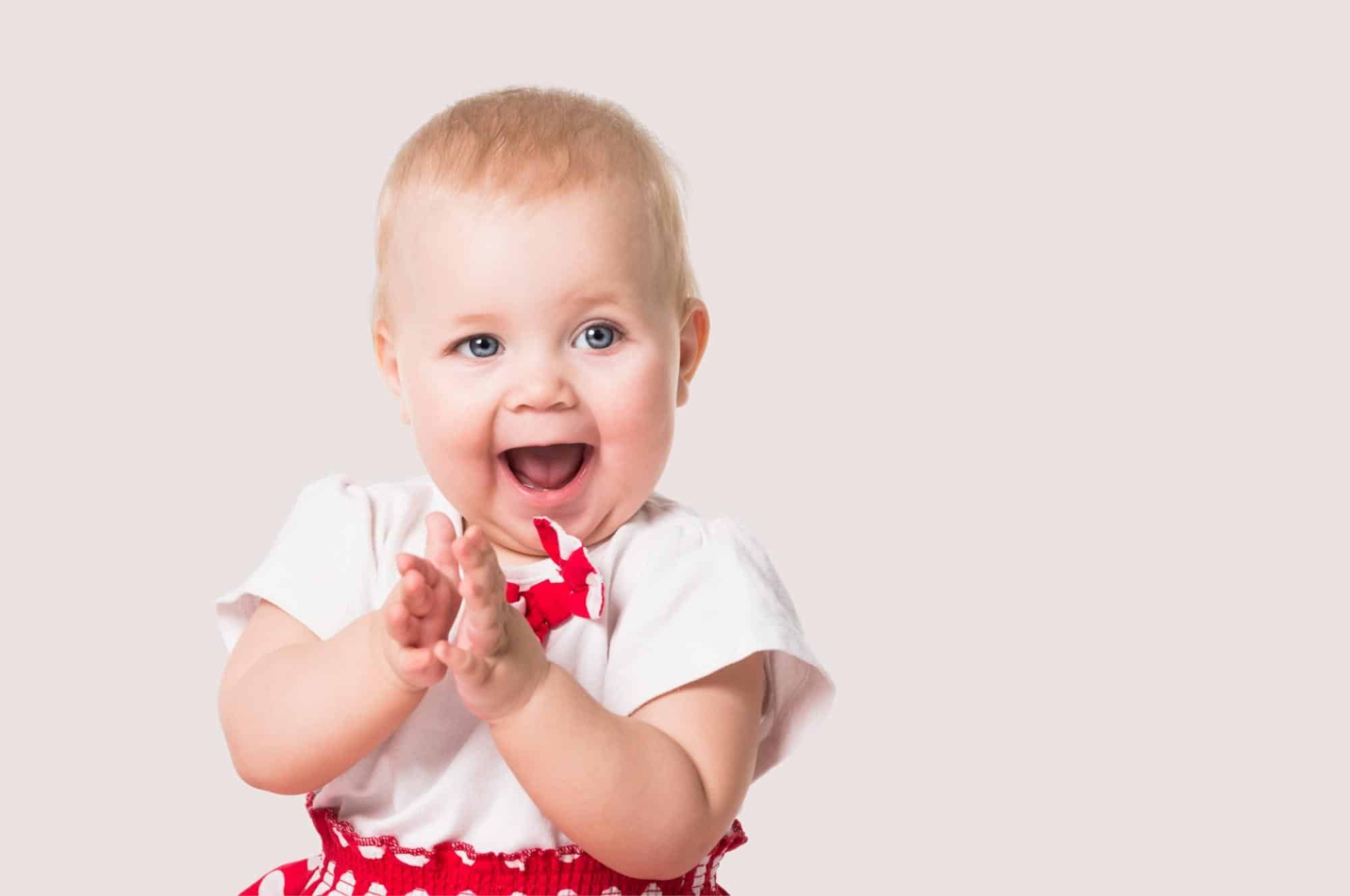 greek girl names feature baby girl clapping hands