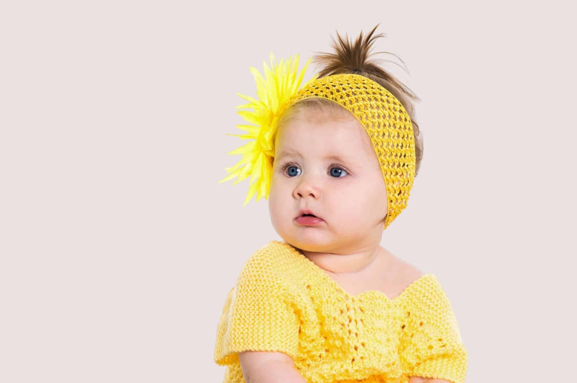 baby girl in yellow shirt headband