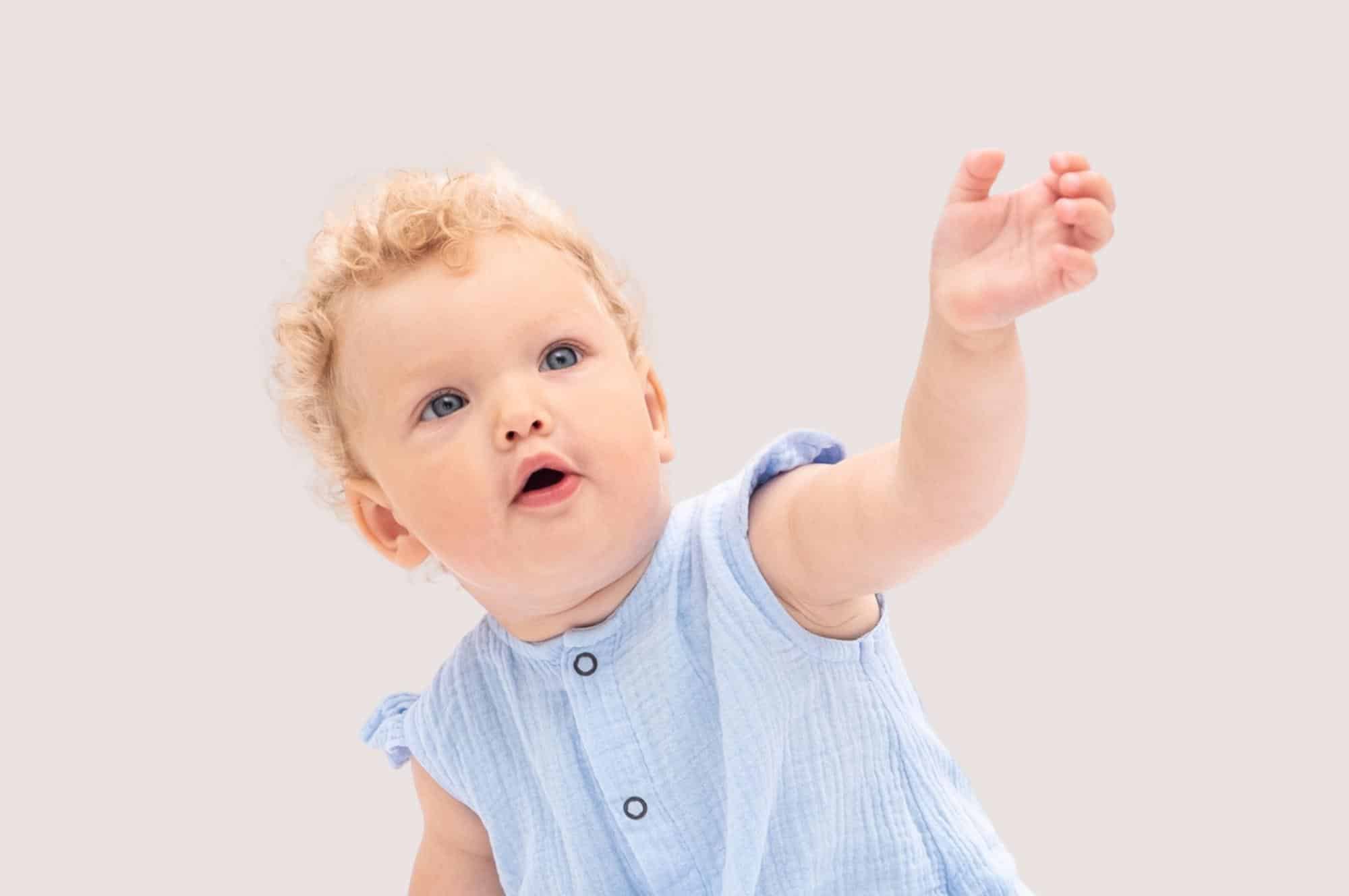 names that mean beautiful feature baby girl blue dress reaching out