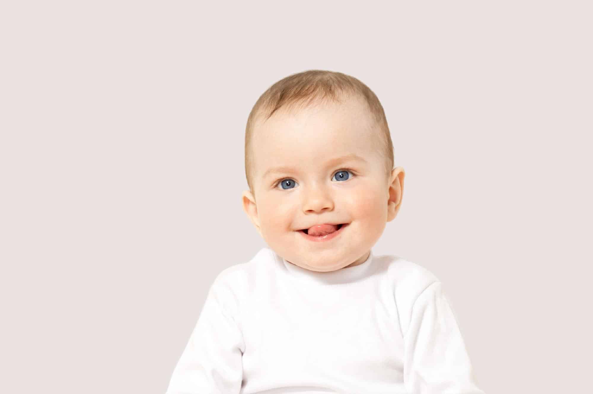 smiling baby boy neutral background