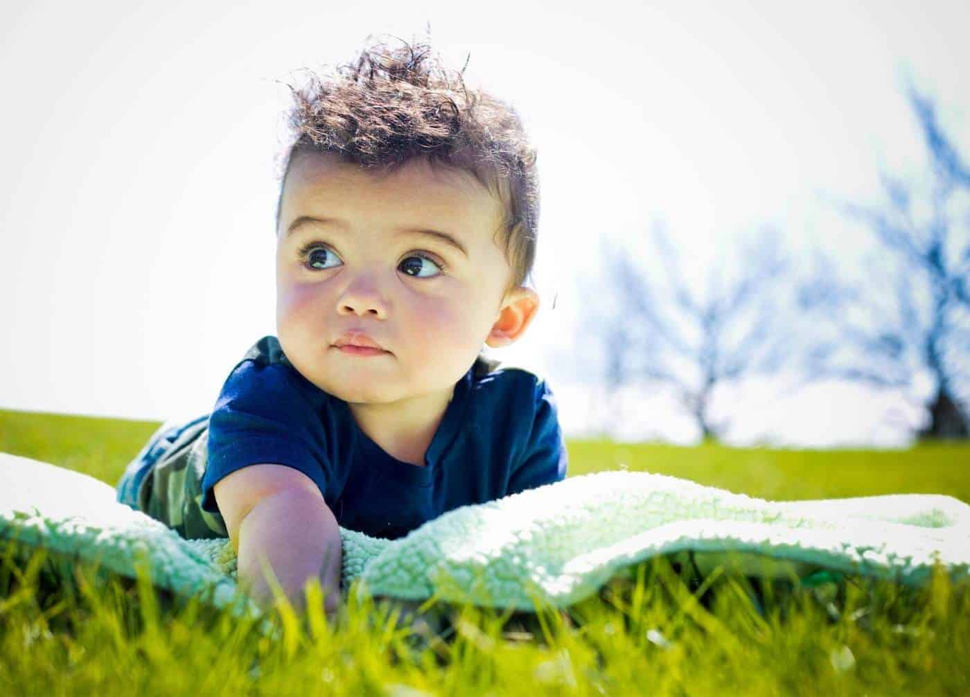 baby boy lying on grass