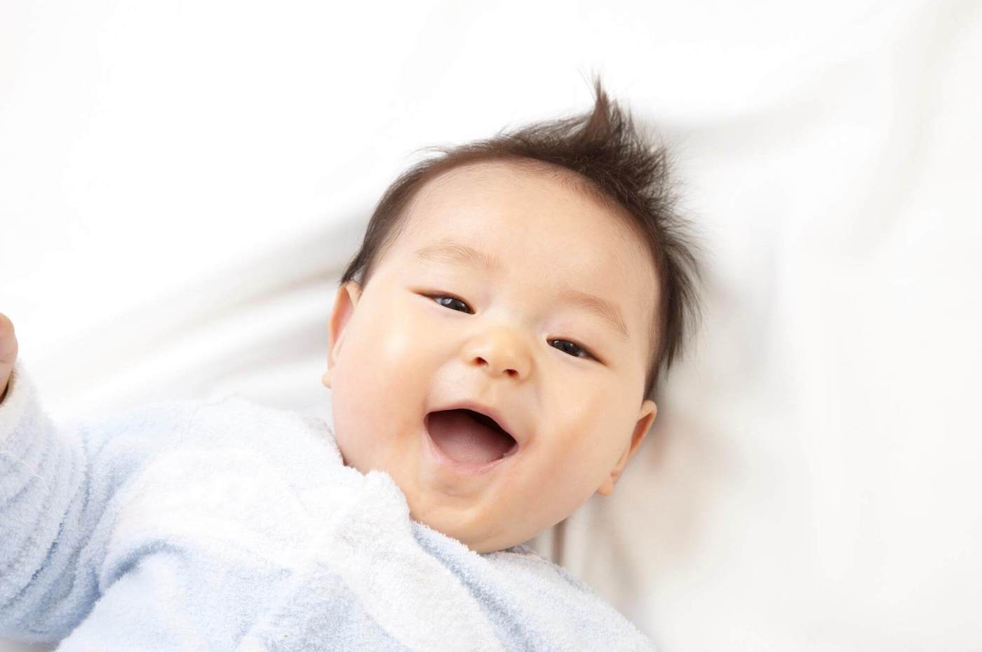 smiling baby boy fluffy hair