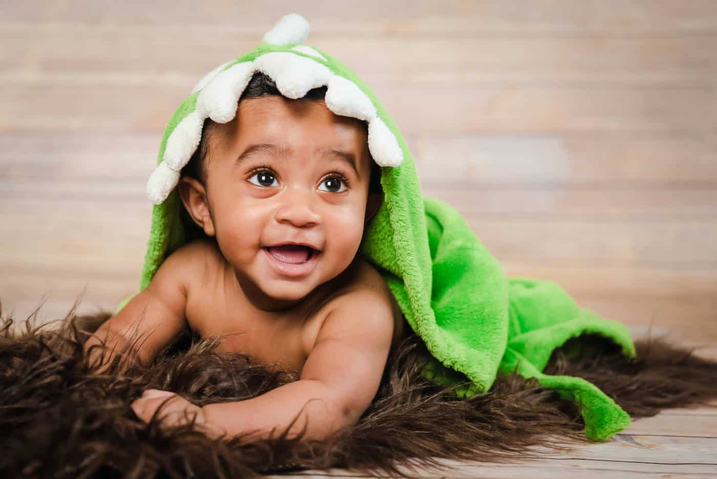 baby boy with dragon blanket on head