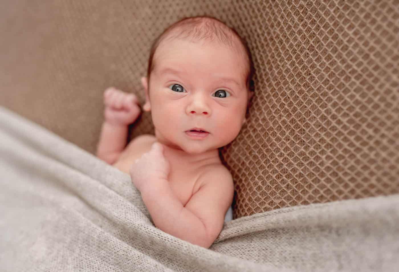 newborn baby boy with open eyes