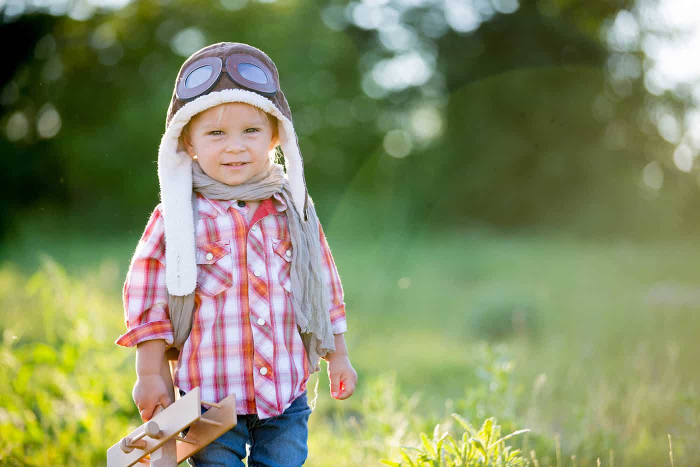 scottish boy with airplane in field