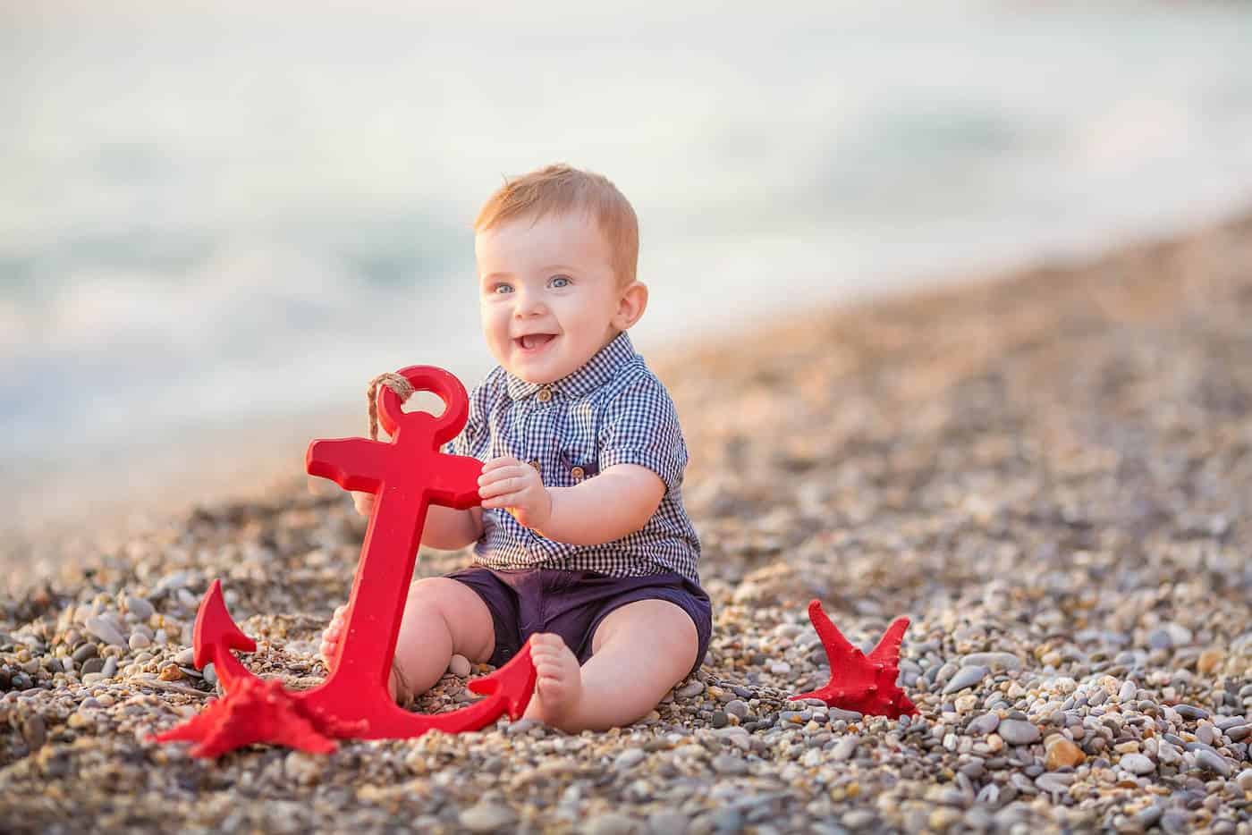 baby boy with anchor by the water
