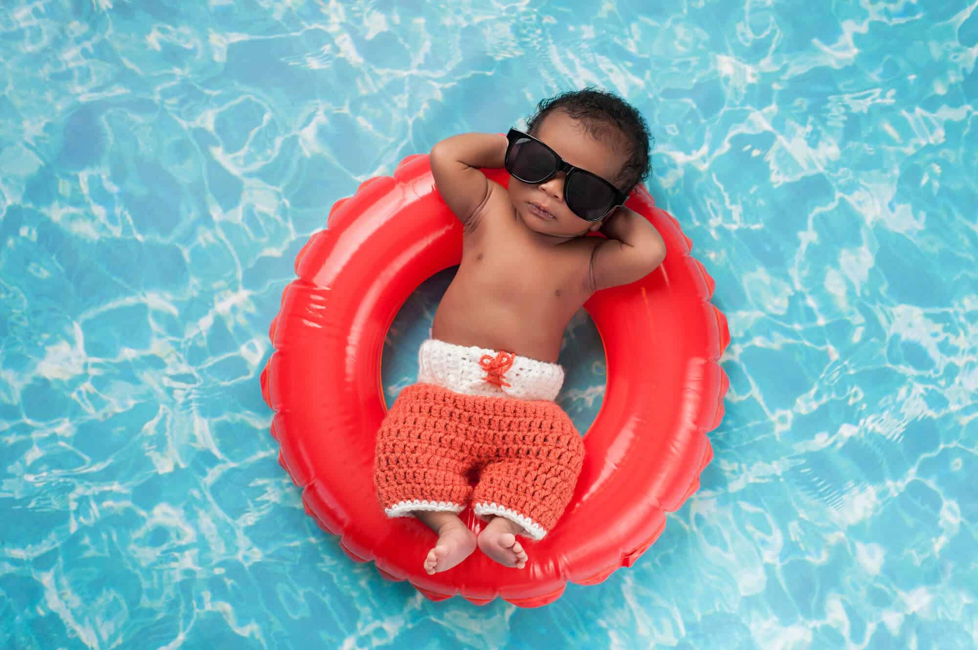 cool baby boy with sunglasses on float
