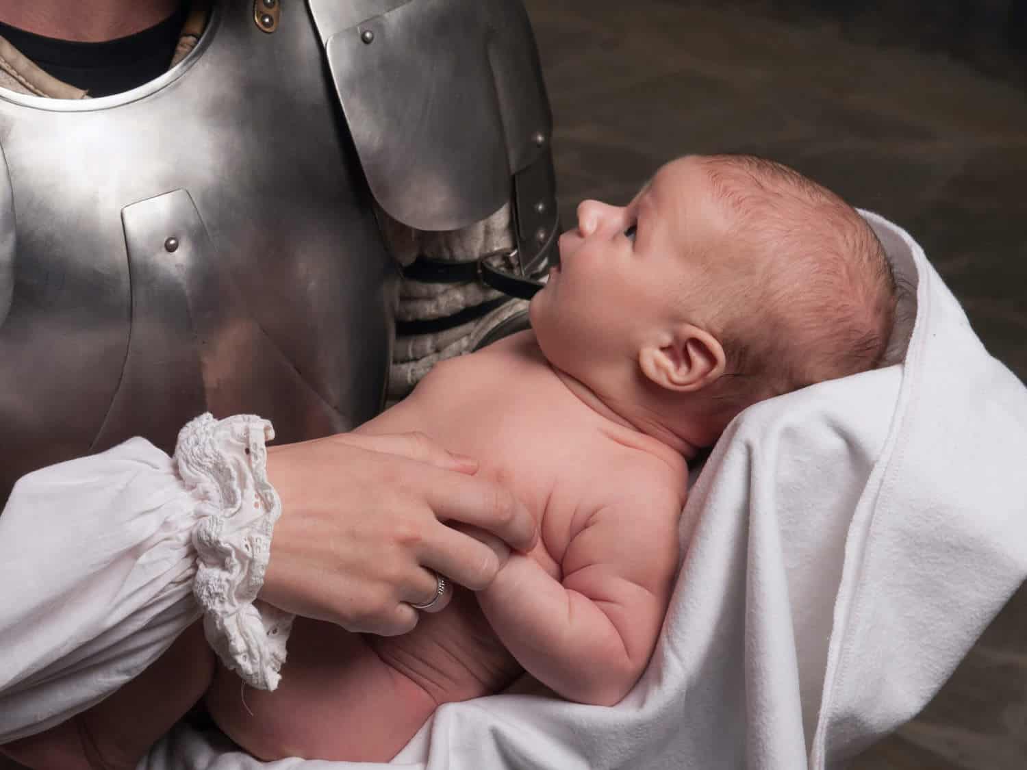 baby boy in arms of armored warrior
