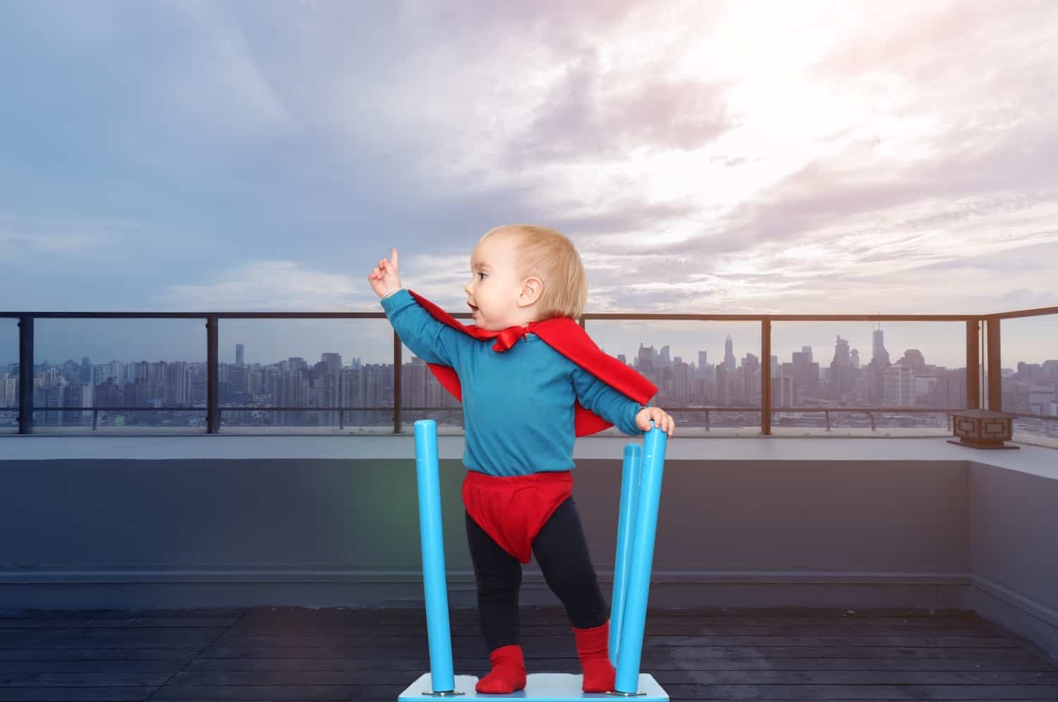 brave little boy superhero outfit on roof