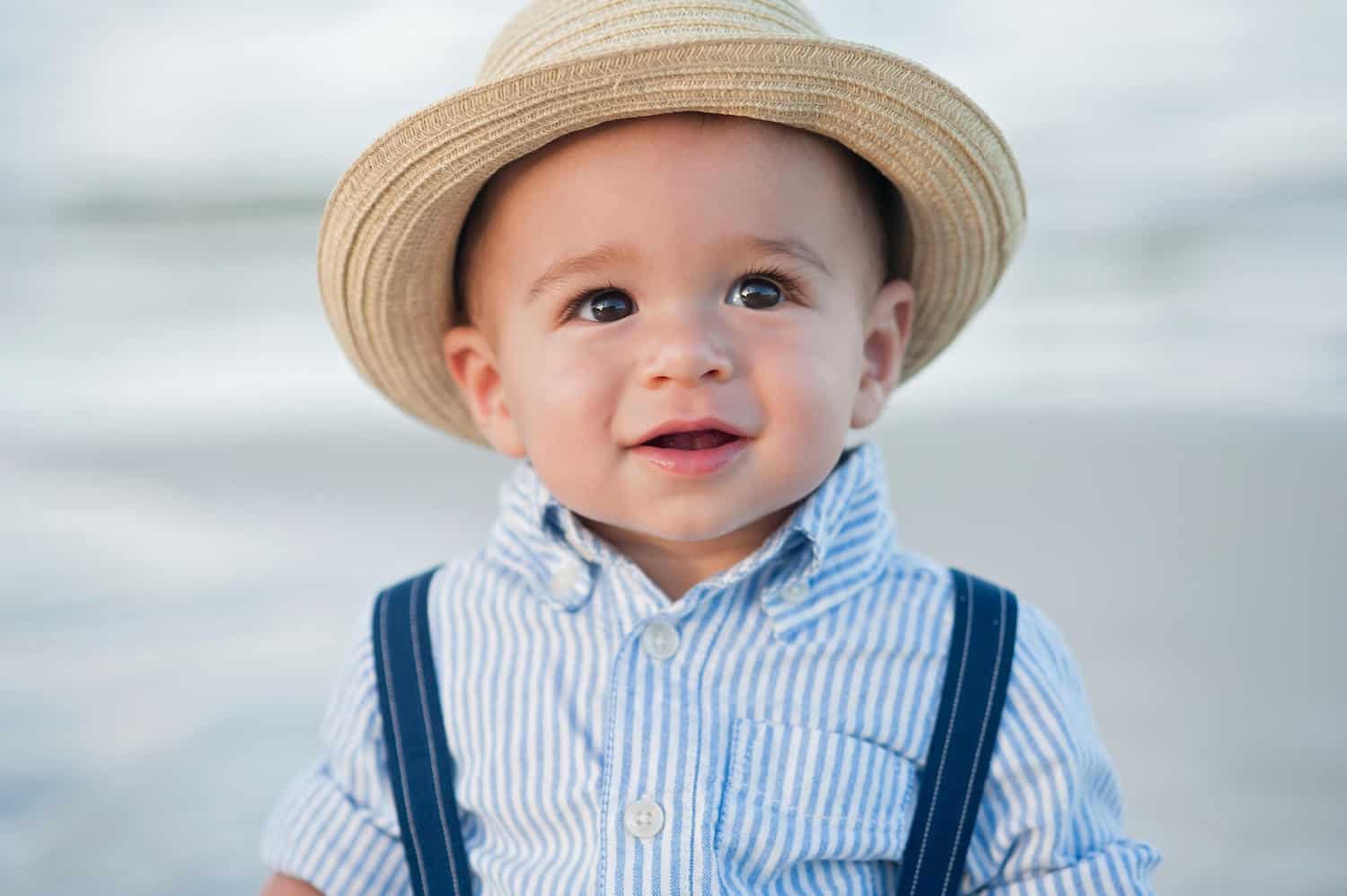baby boy wearing hat suspenders