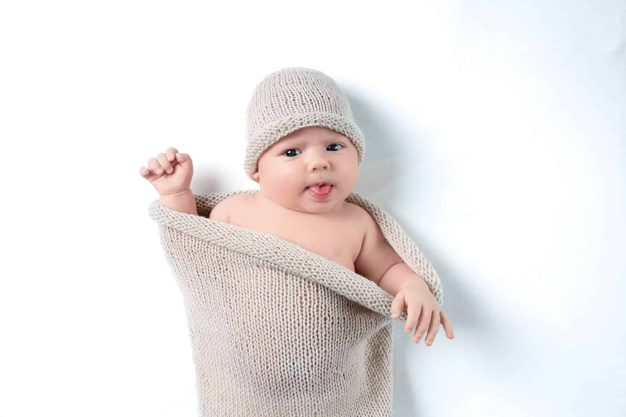 baby boy in beige hat blanket